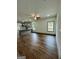 Spacious living area flowing into the open kitchen with sleek hardwood floors at 304 N Dogwood Ave, Social Circle, GA 30025