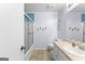 Bright bathroom features a vanity, toilet, and shower with a sliding door, blending style with functionality at 122 Hilo Rd, Fayetteville, GA 30215