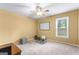 Clean bedroom featuring a window, carpet flooring, and a ceiling fan perfect for customization and relaxation at 122 Hilo Rd, Fayetteville, GA 30215