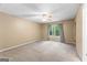 Spacious bedroom featuring neutral carpeting, a large window, and a ceiling fan for added comfort at 122 Hilo Rd, Fayetteville, GA 30215