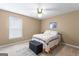 Comfortable bedroom includes carpet flooring, a ceiling fan, a bed with an ottoman, and natural light from the window at 122 Hilo Rd, Fayetteville, GA 30215