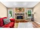 Cozy living room with a stone fireplace and a view of the backyard at 122 Hilo Rd, Fayetteville, GA 30215