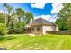 Large, grassy backyard with mature trees and a well-kept lawn at 120 Lyndhurst Way, Sharpsburg, GA 30277