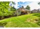 Well-maintained backyard with green lawn, fenced perimeter, and a spacious deck with outdoor seating at 120 Lyndhurst Way, Sharpsburg, GA 30277