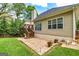 Well-maintained backyard with a patio, deck, and lush green lawn at 120 Lyndhurst Way, Sharpsburg, GA 30277
