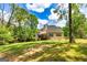Expansive backyard with ample green space and mature trees surrounding the property at 120 Lyndhurst Way, Sharpsburg, GA 30277