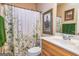 Well-lit bathroom featuring a vanity with a sink and decorative artwork on the walls at 120 Lyndhurst Way, Sharpsburg, GA 30277