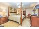 Spacious bedroom with a beautiful four-poster bed and elegant decor at 120 Lyndhurst Way, Sharpsburg, GA 30277