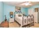 Cozy bedroom with soft blue walls, decorative art, and comfy furniture at 120 Lyndhurst Way, Sharpsburg, GA 30277