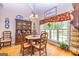 Cozy dining nook featuring hardwood floors, natural light, and an antique hutch at 120 Lyndhurst Way, Sharpsburg, GA 30277