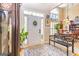 Warm and inviting foyer with a classic rug, a bench, a plant, and a view into the dining room at 120 Lyndhurst Way, Sharpsburg, GA 30277