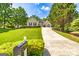 Charming home with manicured lawn, paved driveway, and inviting entrance, showcasing curb appeal at 120 Lyndhurst Way, Sharpsburg, GA 30277
