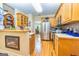 Eat-in kitchen with stainless steel appliances, wood cabinets, and view of the dining room at 120 Lyndhurst Way, Sharpsburg, GA 30277