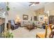Bright living room featuring high ceilings, a fireplace, comfortable seating, and an ornate coffee table at 120 Lyndhurst Way, Sharpsburg, GA 30277