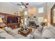 Inviting living room with soaring ceilings, stone fireplace, a ceiling fan and ample seating at 120 Lyndhurst Way, Sharpsburg, GA 30277