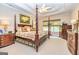 Elegant main bedroom with four-poster bed, tray ceiling, and decorative furnishings at 120 Lyndhurst Way, Sharpsburg, GA 30277
