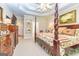 Comfortable main bedroom featuring a decorative four-poster bed, soft lighting, and classic furnishings at 120 Lyndhurst Way, Sharpsburg, GA 30277