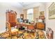Cozy office with a large desk, elegant furnishings, and a well-lit window at 120 Lyndhurst Way, Sharpsburg, GA 30277