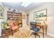 Inviting home office featuring classic furniture, built-in bookshelves, and an elegant rug at 120 Lyndhurst Way, Sharpsburg, GA 30277