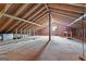 Unfinished attic with exposed beams, wood floors and one window at 195 Blackberry Run, Fayetteville, GA 30214