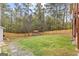 Large fenced backyard featuring a storage shed and mature trees at 195 Blackberry Run, Fayetteville, GA 30214