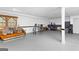 Large basement area with painted floors, drop ceiling, large window, and neutral walls at 195 Blackberry Run, Fayetteville, GA 30214