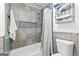 Bathroom featuring tiled walls, shower with curtain, and a shelf with towels and toilet paper at 195 Blackberry Run, Fayetteville, GA 30214