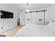 Bedroom with a white bed set, modern lighting, a plant and bright windows at 195 Blackberry Run, Fayetteville, GA 30214
