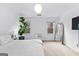 Bedroom with a white bed set, modern lighting, a plant and bright windows at 195 Blackberry Run, Fayetteville, GA 30214