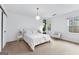 Bedroom with a white bed set, modern lighting, a plant and bright windows at 195 Blackberry Run, Fayetteville, GA 30214
