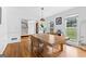 Elegant dining area with modern table and chairs, and gleaming hardwood floors at 195 Blackberry Run, Fayetteville, GA 30214