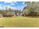 Charming home with a manicured lawn and flowering trees on a sunny day at 195 Blackberry Run, Fayetteville, GA 30214