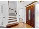 Welcoming foyer with hardwood floors, staircase, and view of the powder room at 195 Blackberry Run, Fayetteville, GA 30214