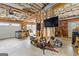 Garage framing featuring exposed structural beams, garage door, and lawn care tools at 195 Blackberry Run, Fayetteville, GA 30214