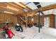 Spacious garage interior with work bench, stairs, and multiple motorcycles and four wheelers at 195 Blackberry Run, Fayetteville, GA 30214