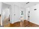 Hallway with hardwood flooring leading to bedrooms, featuring white walls and trim throughout at 195 Blackberry Run, Fayetteville, GA 30214