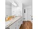 Elegant main bathroom featuring double sinks, granite countertop, and hardwood flooring at 195 Blackberry Run, Fayetteville, GA 30214
