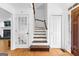 Bright foyer with wooden staircase, hardwood floors, and a decorative glass paneled door at 195 Blackberry Run, Fayetteville, GA 30214