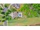 Aerial view of the house overlooking a large green backyard, pool and lounge area and neighborhood at 215 Sheridan Ln, Peachtree City, GA 30269