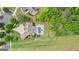 Aerial view of the house overlooking a large green backyard, pool and lounge area and wooded areas at 215 Sheridan Ln, Peachtree City, GA 30269