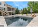 View of the swimming pool, hot tub, and backyard of the home, including the screened in porch at 215 Sheridan Ln, Peachtree City, GA 30269