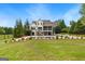 Exterior of the house overlooking a large green backyard, pool and lounge area at 215 Sheridan Ln, Peachtree City, GA 30269