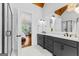 Stylish bathroom featuring double vanity, marble floors, and wood beam ceiling at 215 Sheridan Ln, Peachtree City, GA 30269