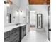 Stylish bathroom features double vanity, marble floors, and wood beam ceiling at 215 Sheridan Ln, Peachtree City, GA 30269