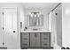 Modern bathroom featuring a gray vanity with a marble countertop and a framed mirror at 215 Sheridan Ln, Peachtree City, GA 30269