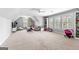Large bonus room with comfortable seating, window seating with custom shelving, and ample play space at 215 Sheridan Ln, Peachtree City, GA 30269