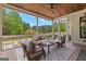 Beautiful covered porch featuring wood ceiling, comfortable seating, and a serene view of the outdoors at 215 Sheridan Ln, Peachtree City, GA 30269