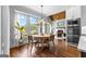 Bright dining area featuring large windows open to a spacious living area with fireplace and stainless steel appliances at 215 Sheridan Ln, Peachtree City, GA 30269
