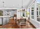 Bright dining area featuring large windows and a modern chandelier open to kitchen and living area at 215 Sheridan Ln, Peachtree City, GA 30269