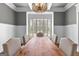 Bright dining room features a wooden table and large window with plantation shutters at 215 Sheridan Ln, Peachtree City, GA 30269